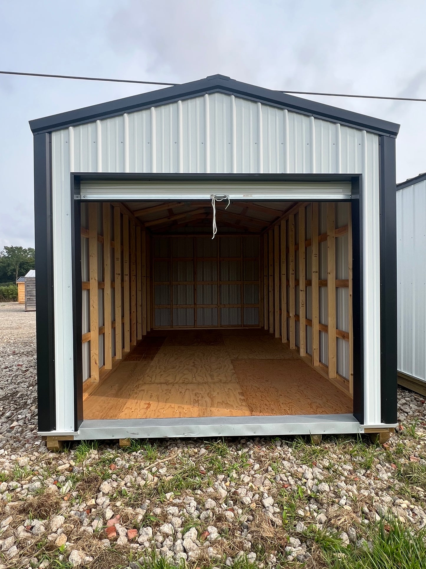 10x20 white steel shed with 8' roll up door
