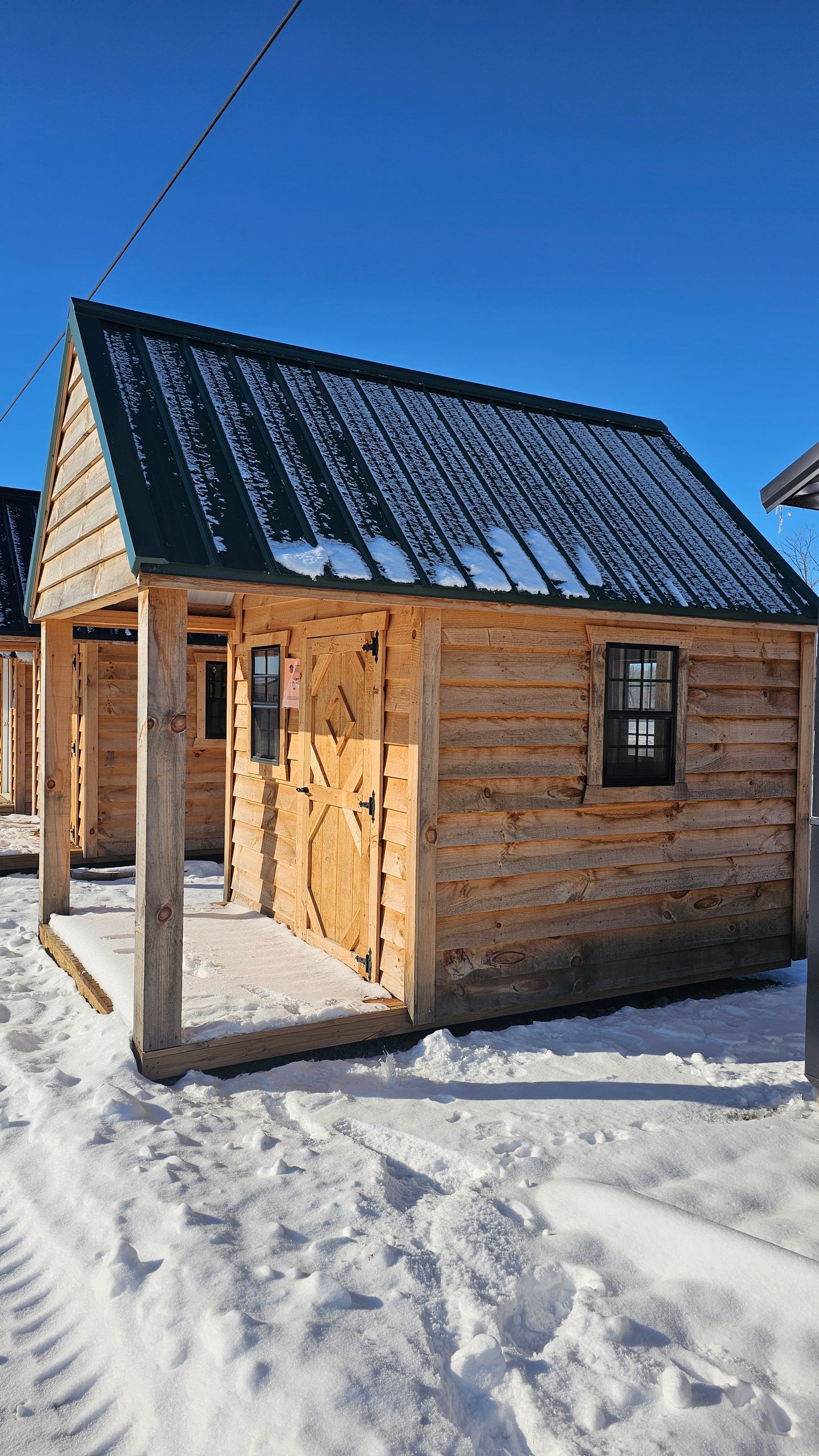 8×12 Rough Sawn Cabin with 8×8 Enclosed 4′ Porch – Green Steel Roof